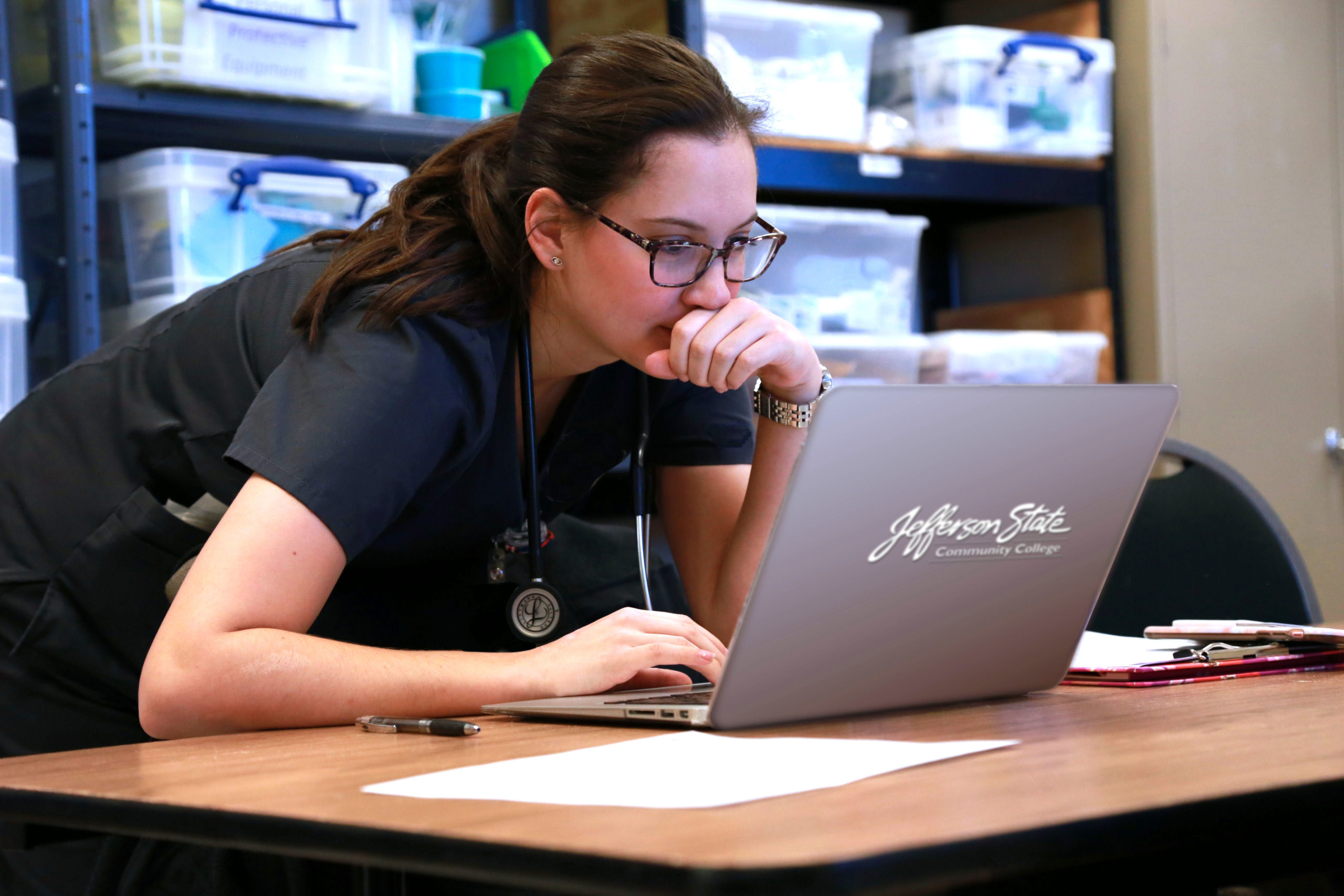 Nurse Looking at Laptop JSCC LOGO