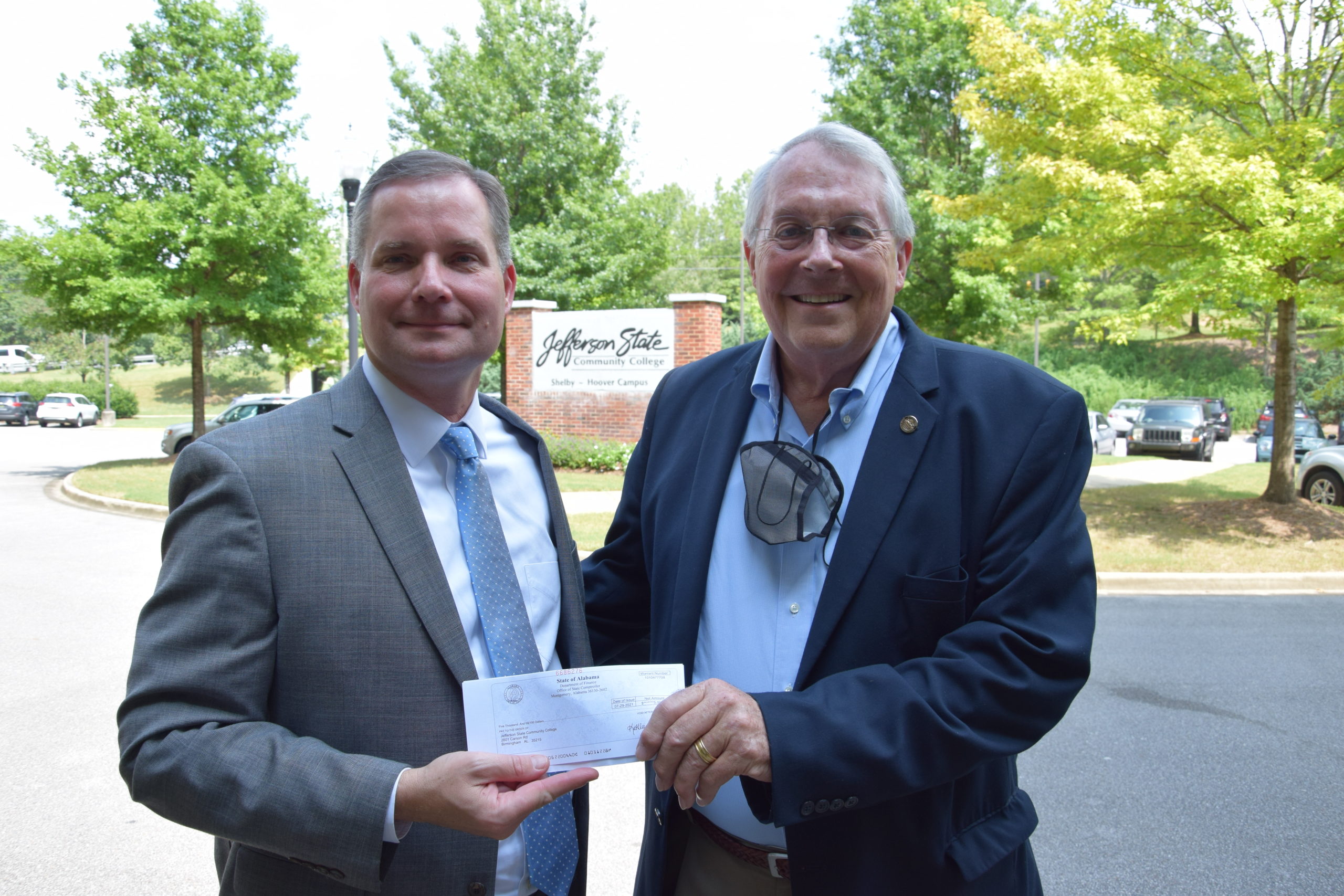 Jefferson State President Keith Brown, left, accepts a check from Rep. Arnold Mooney.