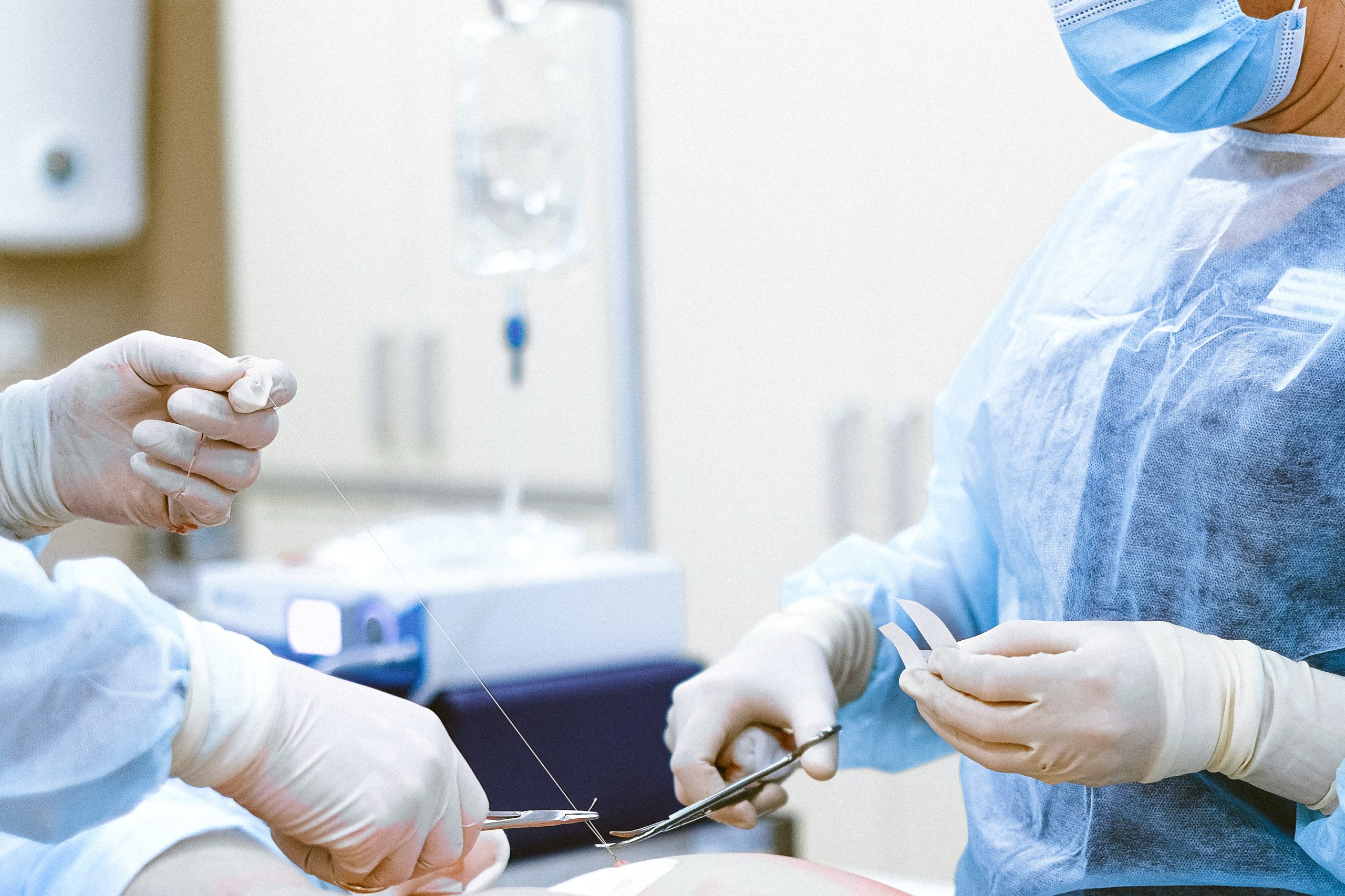 surgeon and assistant perform a medical procedure