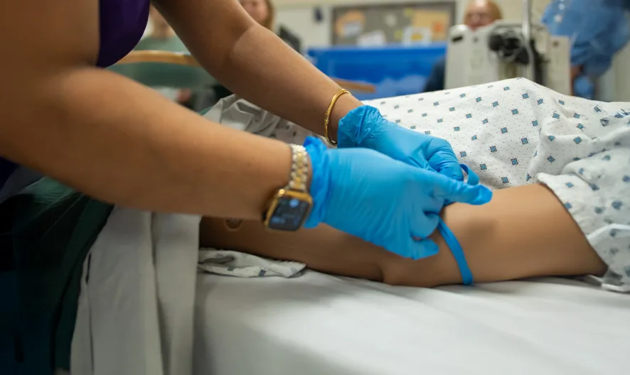 A person in gloves putting on a leg.