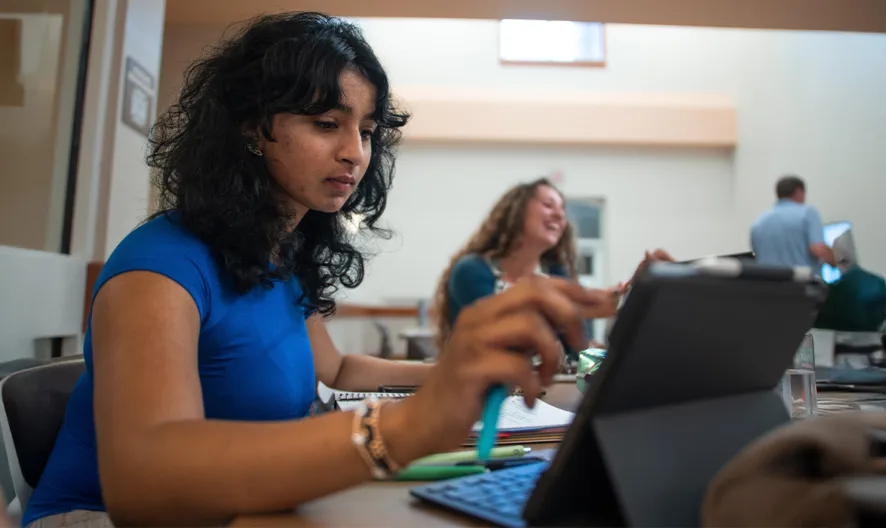 A woman using a tablet.