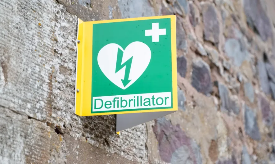 Image of a sign attached to a wall sign reads: "defibrillator"