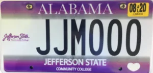 Alabama license plate with JJM000, a Jefferson State Community College logo, and an August 2020 registration sticker. The plate has purple accents and a white heart shape in the lower right corner.