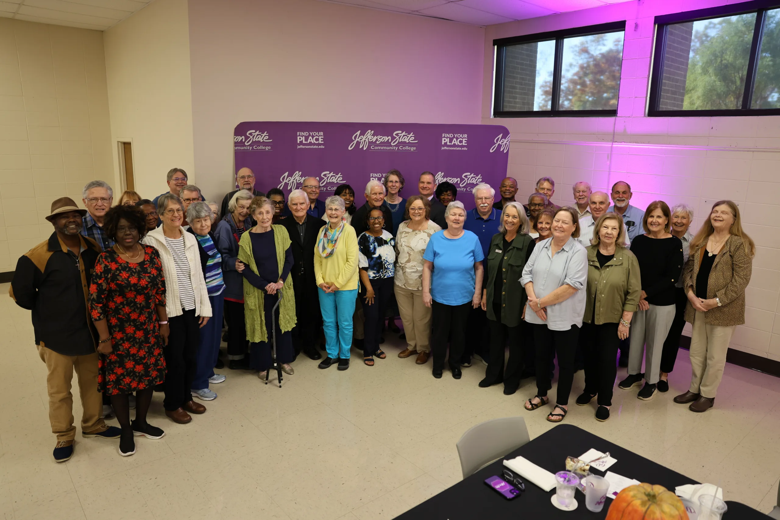 2025 Retiree luncheon attendees pose for group picture.