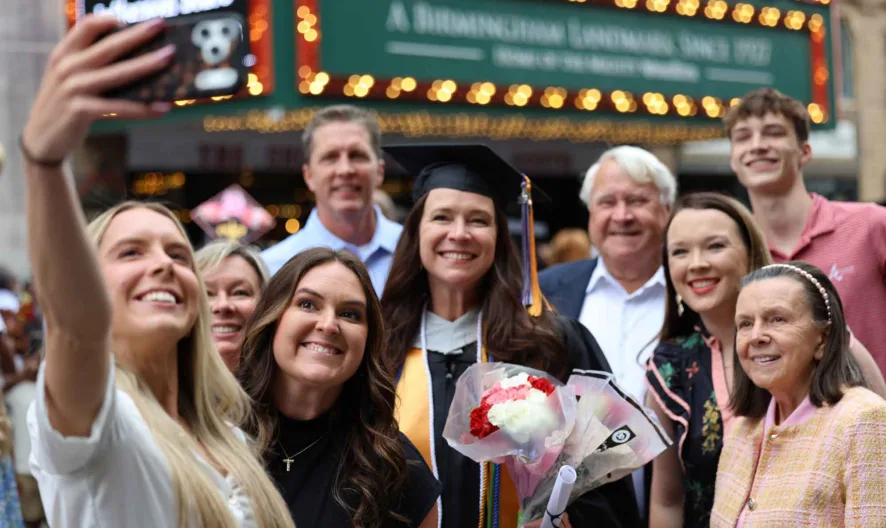 Graduate pose for picture with family