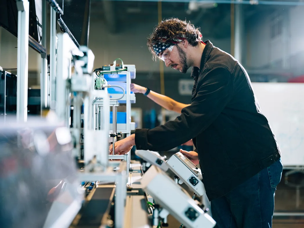 Automotive technician works with electronic equipment