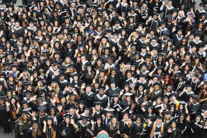 Graduates pose for picture outside in front of The Alabama Theatre
