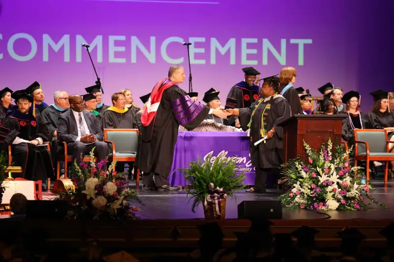 President Brown hands out diploma at ceremony