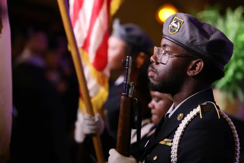 Graduates stand for flag ceremony