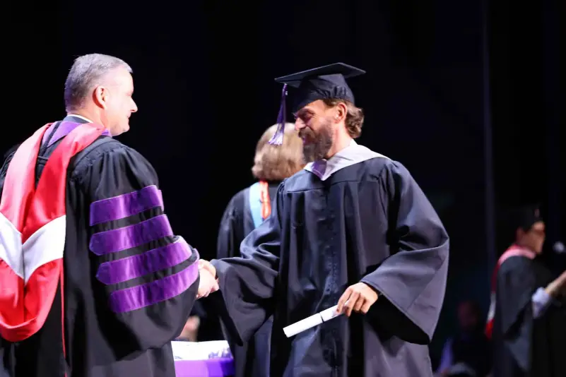President Brown hands out diploma at ceremony