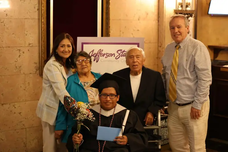 Graduate pose for picture with family