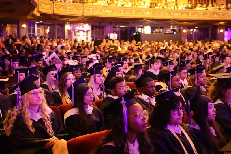 Graduates listen to commencement speaker