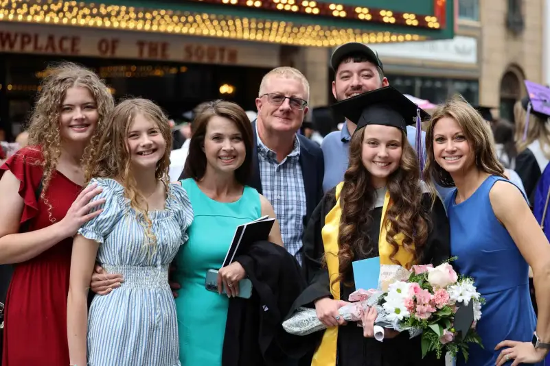 Graduate pose for picture with family
