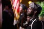Graduates stand for flag ceremony