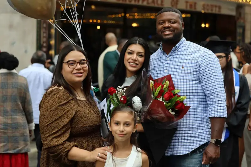 Graduate pose for picture with family