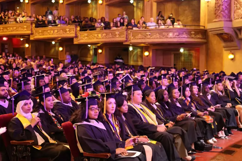 Graduates listen to commencement speaker