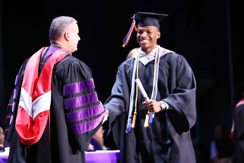 President Brown hands out diploma at ceremony