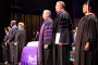 President, faculty and Staff stand for graduation cermony