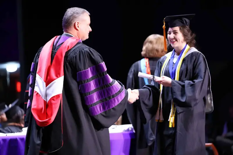 President Brown hands out diploma at ceremony