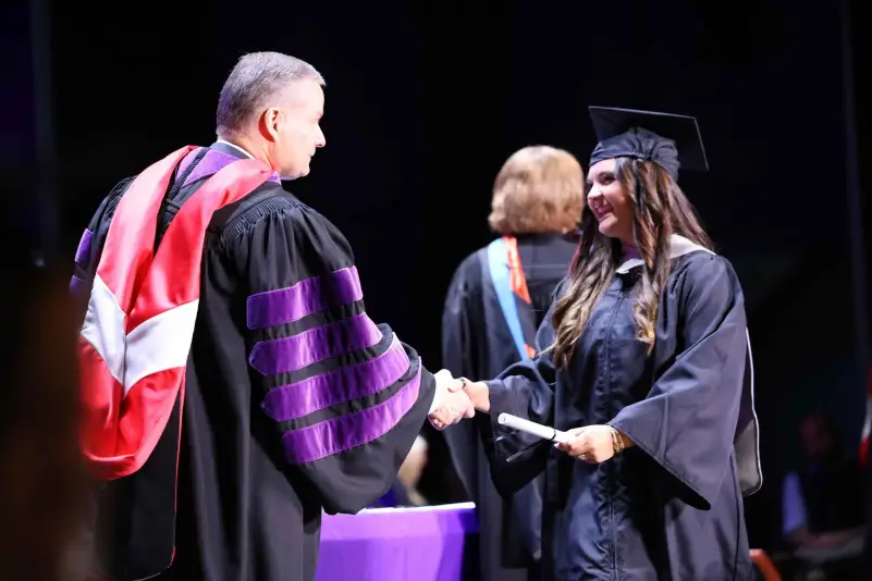 President Brown hands out diploma at ceremony