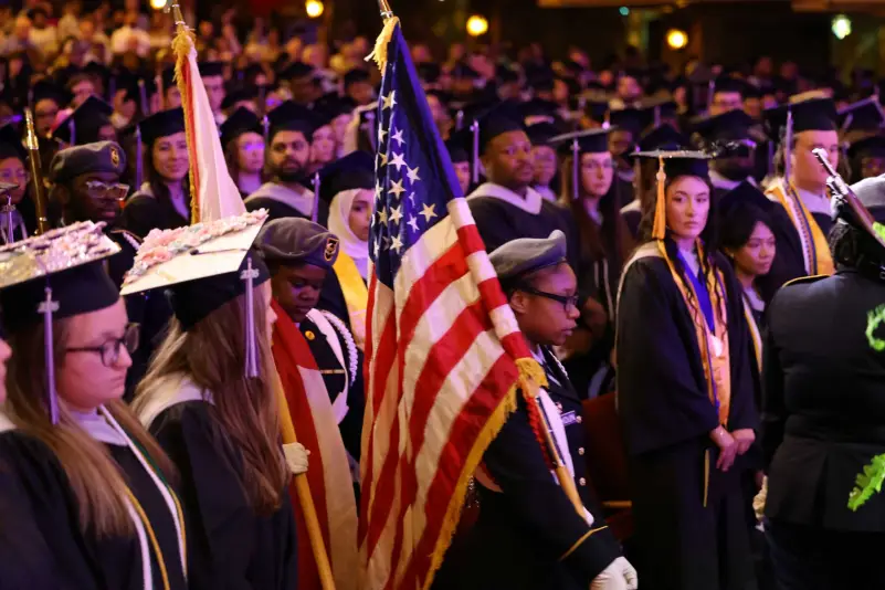 Graduates stand for flag ceremony