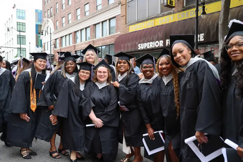 Graduates pose outside for picture