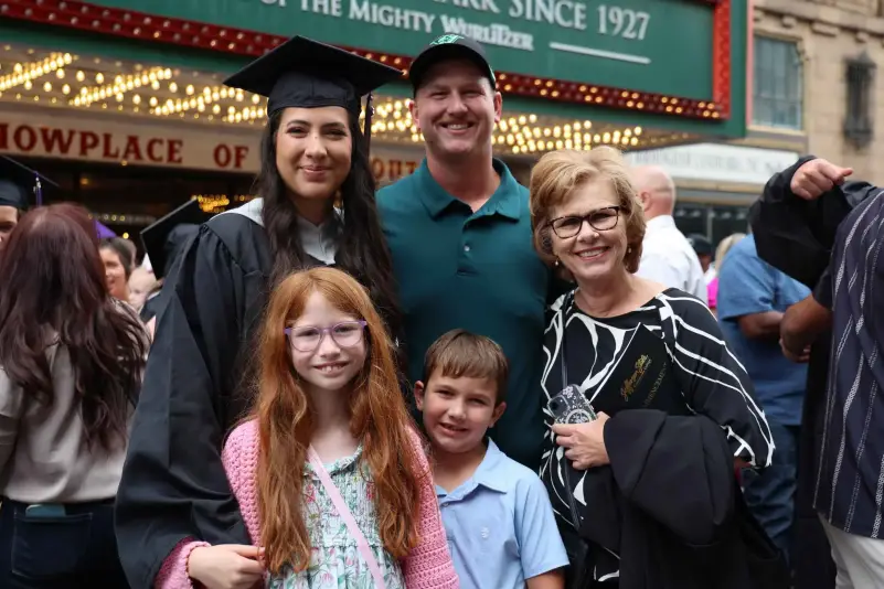 Graduate pose for picture with family