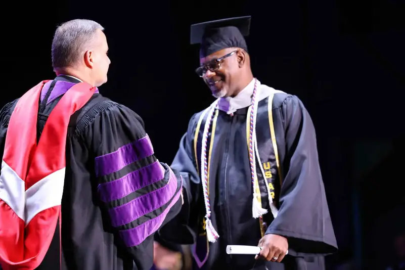 President Brown hands out diploma at ceremony