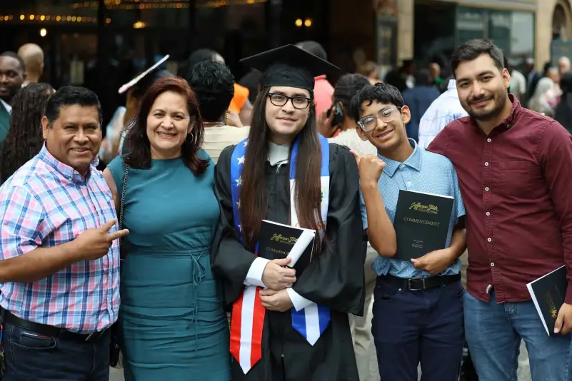 Graduate pose for picture with family