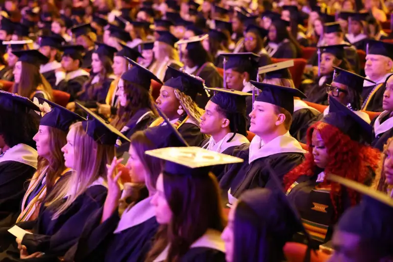 Graduates listen to commencement speaker
