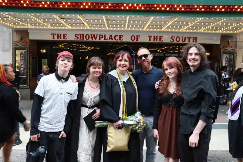 Graduate pose for picture with family