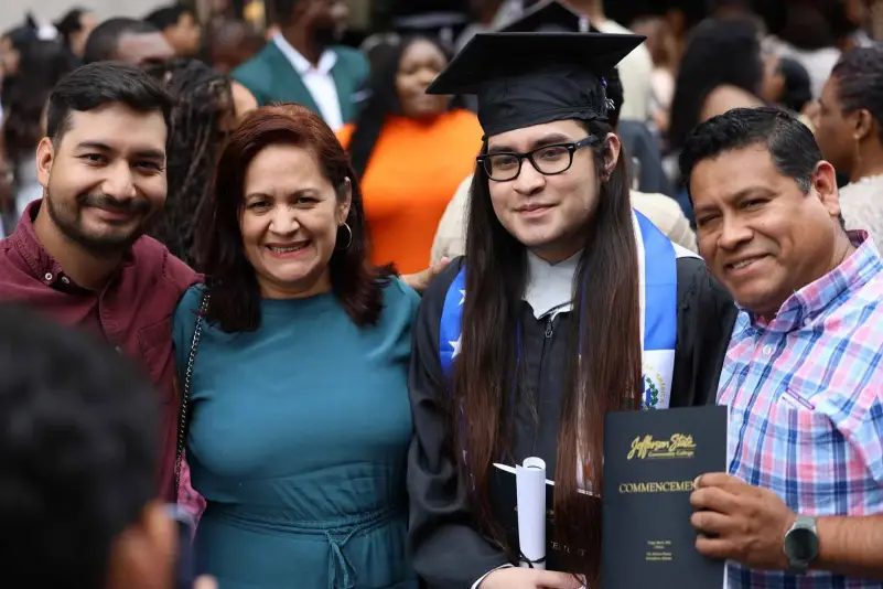 Graduate pose for picture with family