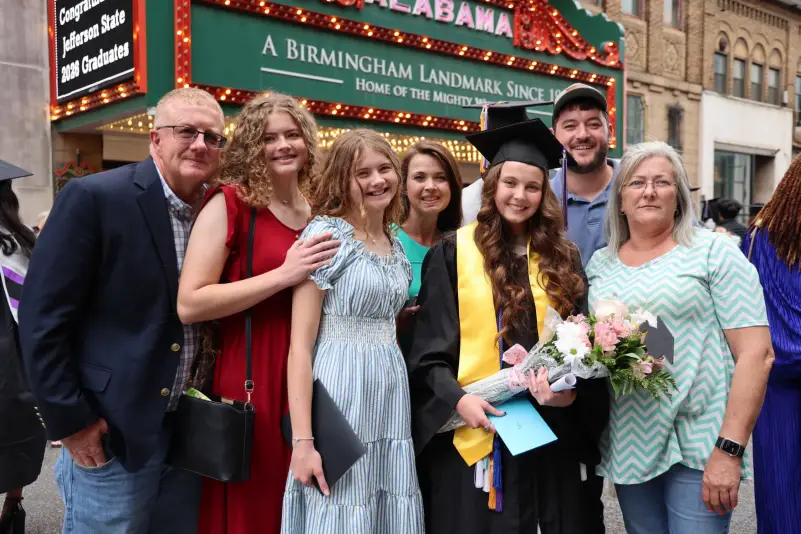 Graduate pose for picture with family