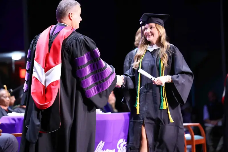 President Brown hands out diploma at ceremony
