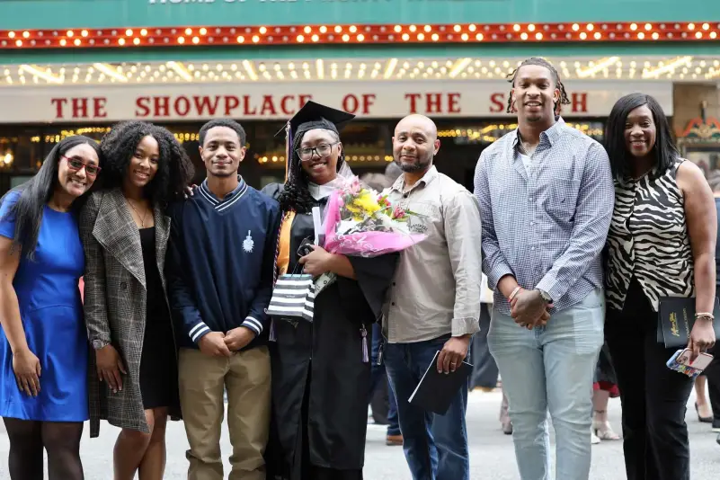 Graduate pose for picture with family
