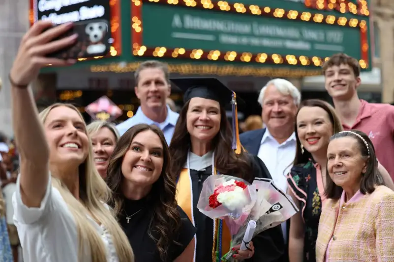 Graduate pose for picture with family